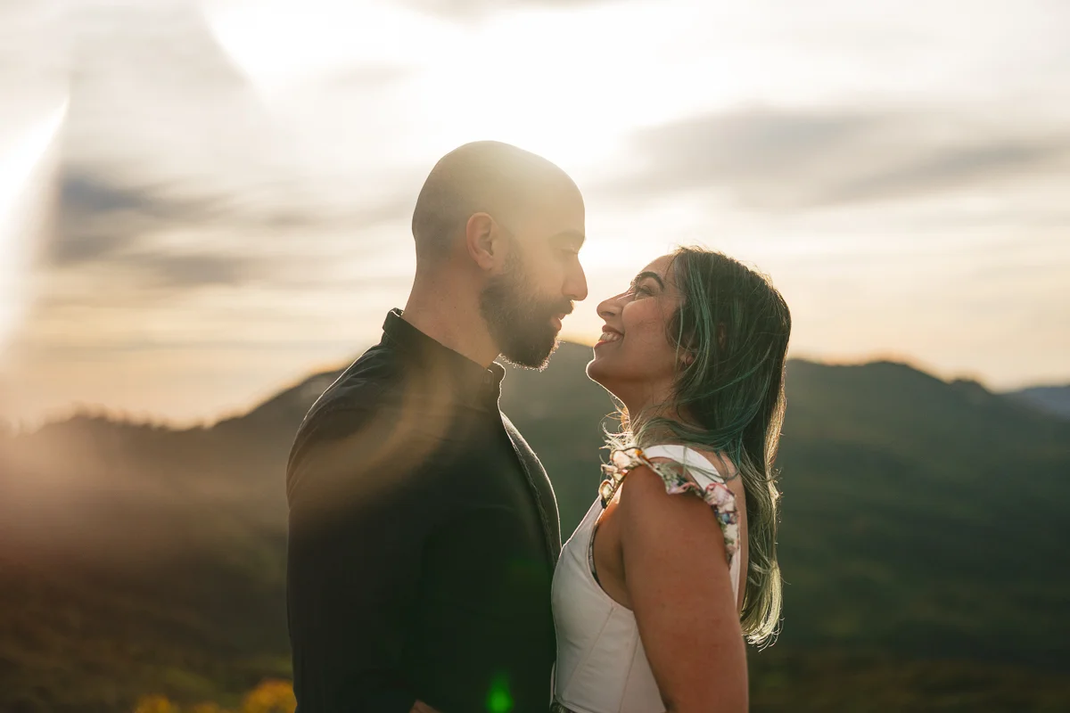 Couple Kissing at sunset with lens flare