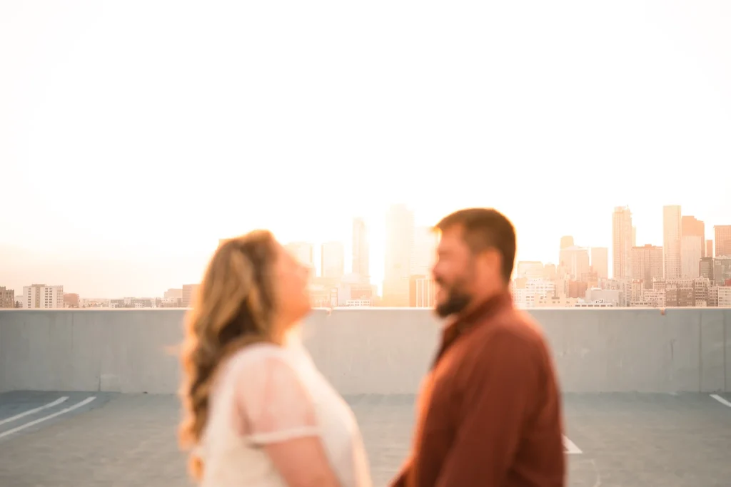 Couple holding hands on rooftop at sunset