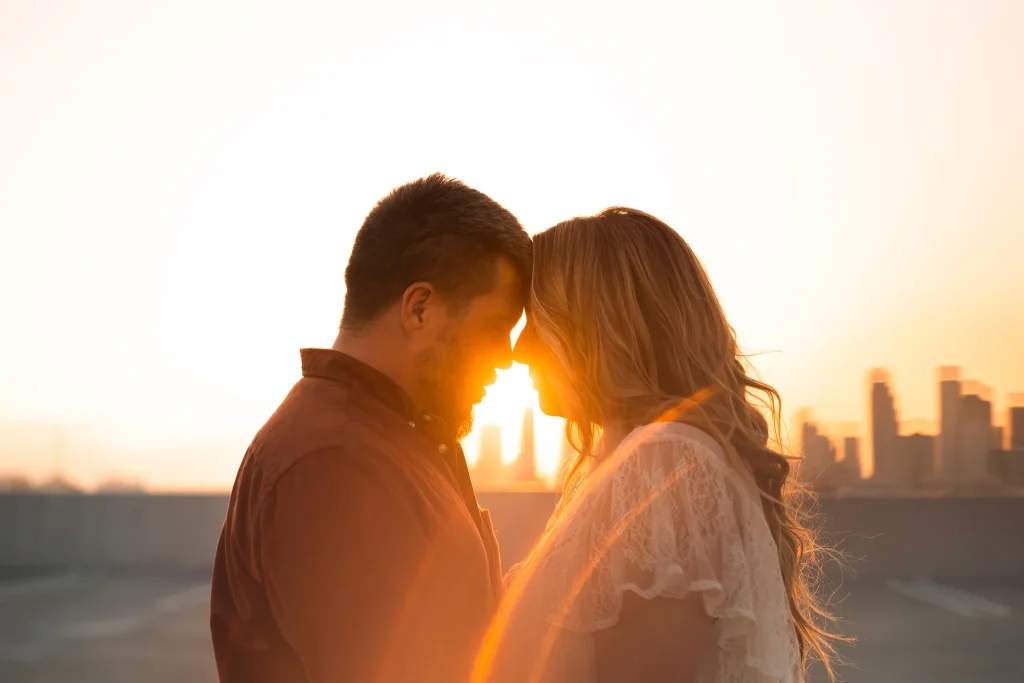 Bride and Groom touching foreheads on rooftop
