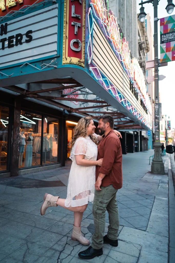 Couple kissing in front of the rialto sign in downtown