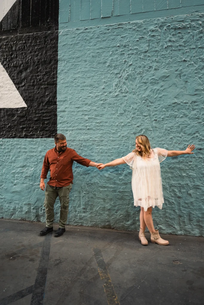 Engaged couple dancing in parking lot in Downtown LA