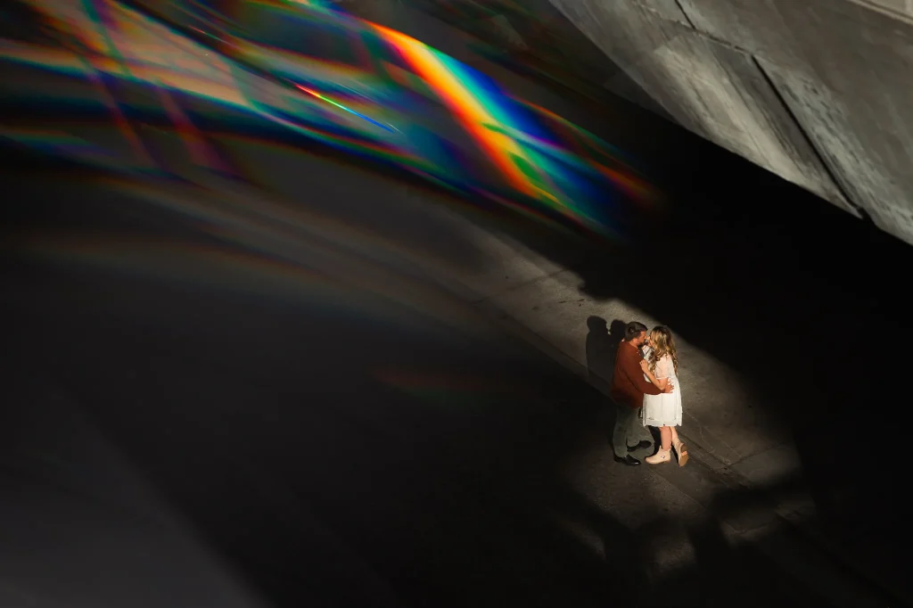 Engaged Couple kissing in tunnel with flare