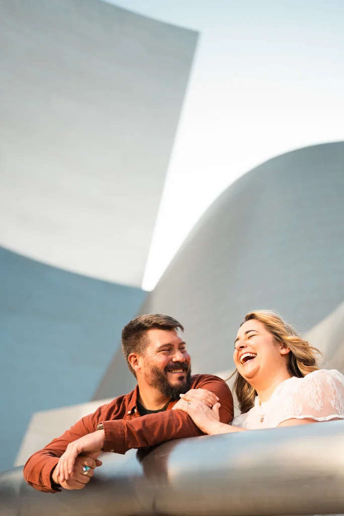 Engaged couple laughing at the walt disney conceret hall in downtown los angeles