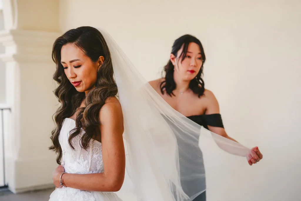 Bridesmaids adjust brides veil at Talega Golf Club