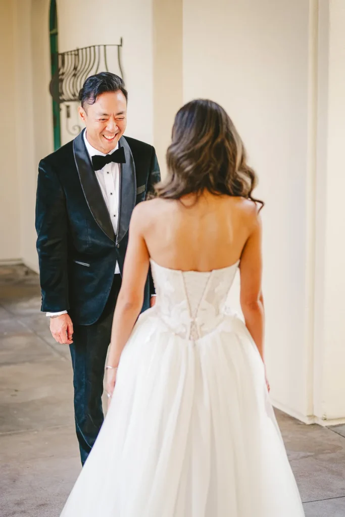 Groom smiles during first look at bride